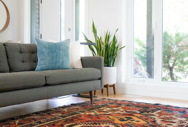 Colorful Oriental rug in a modern living room with sunlight shining through large windows – professionally cleaned to restore vibrant patterns and colors.