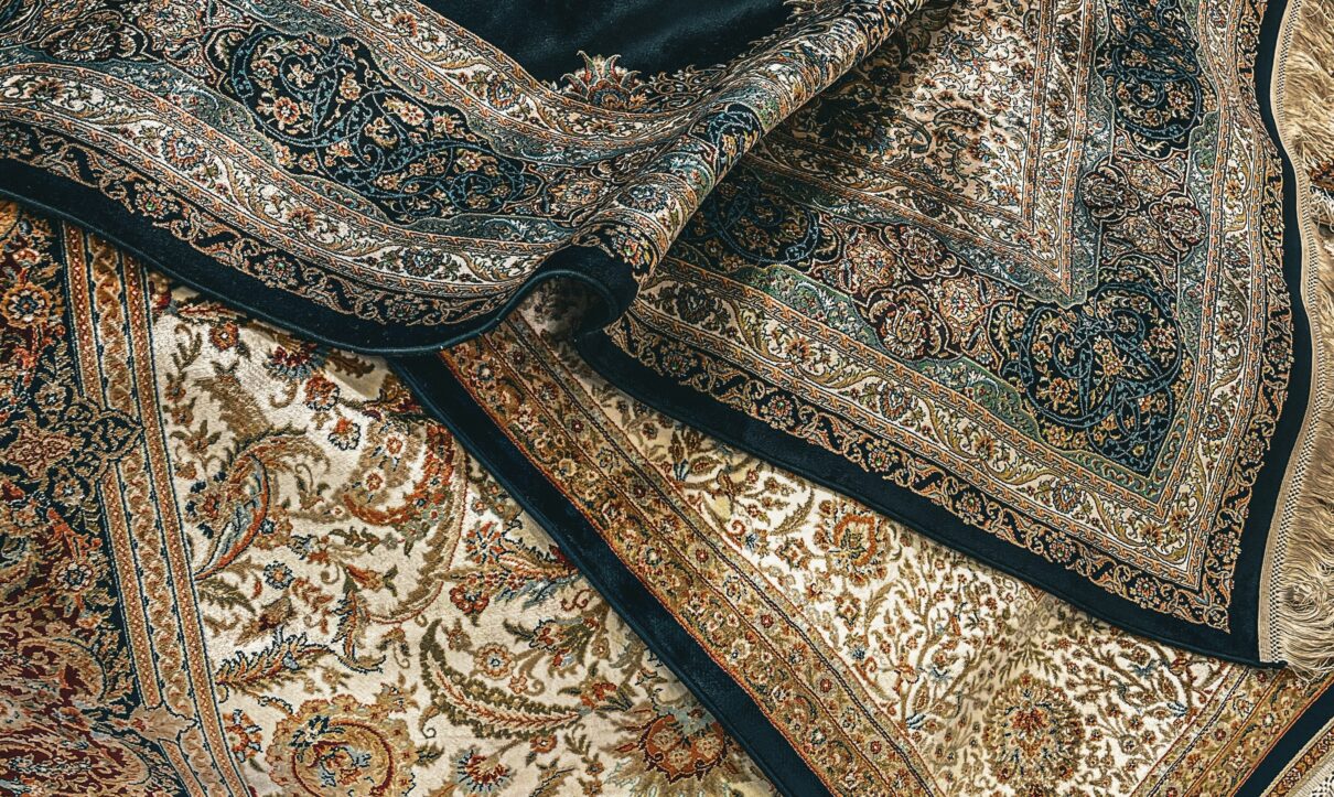 Close-up of luxurious handmade Oriental rugs with intricate patterns and rich colors, ideal for professional rug cleaning and restoration services in Dallas-Fort Worth