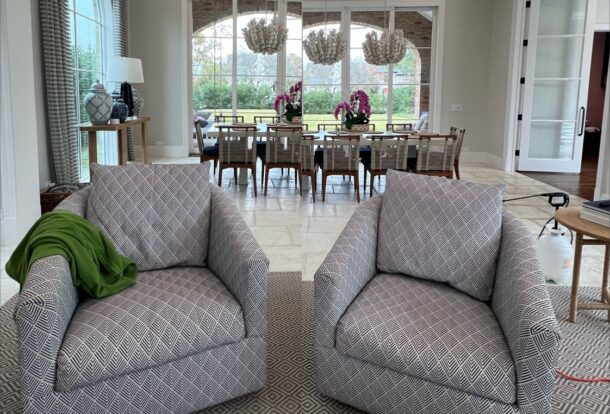 A pair of upholstered armchairs in a clean and bright living room setting, showcasing freshly cleaned fabric with vibrant patterns